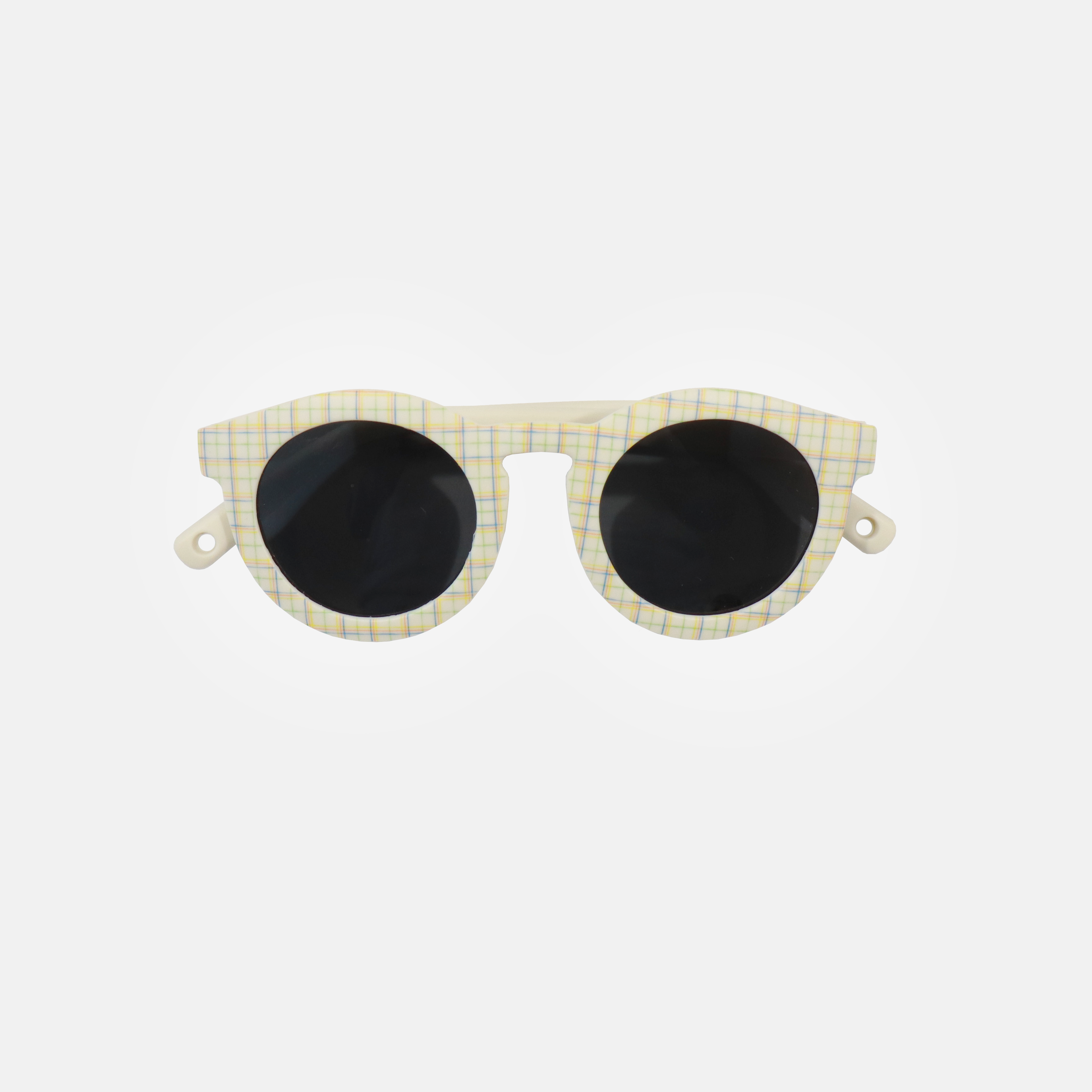 Lunettes de soleil pour enfants avec monture ronde à motif tartan, branches souples crème, et verres noirs polarisés – modèle Hop'Pop CAT4, conçu pour une haute protection anti-UV.