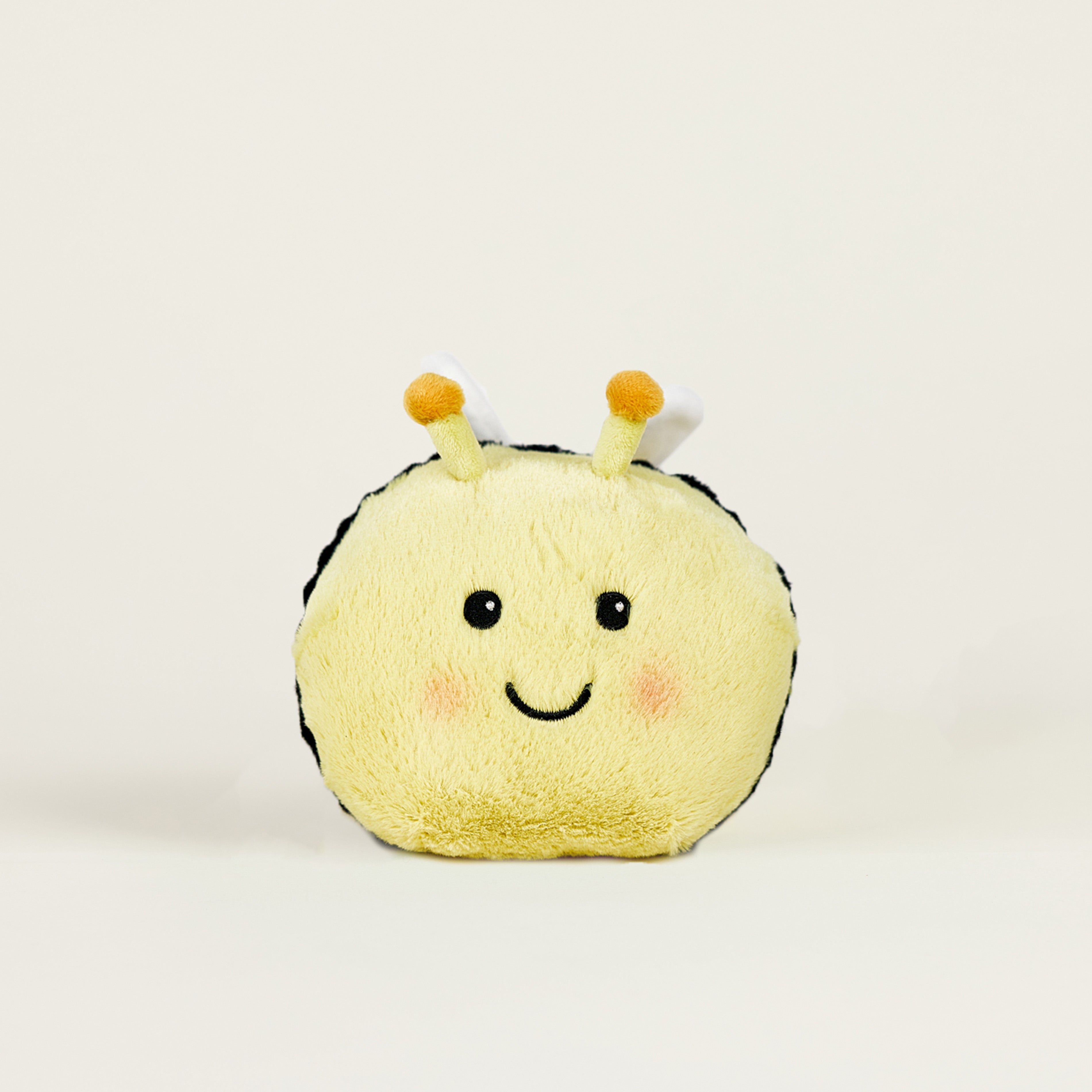 Peluche bouillotte juniors abeille jaune, de face avec un sourire 