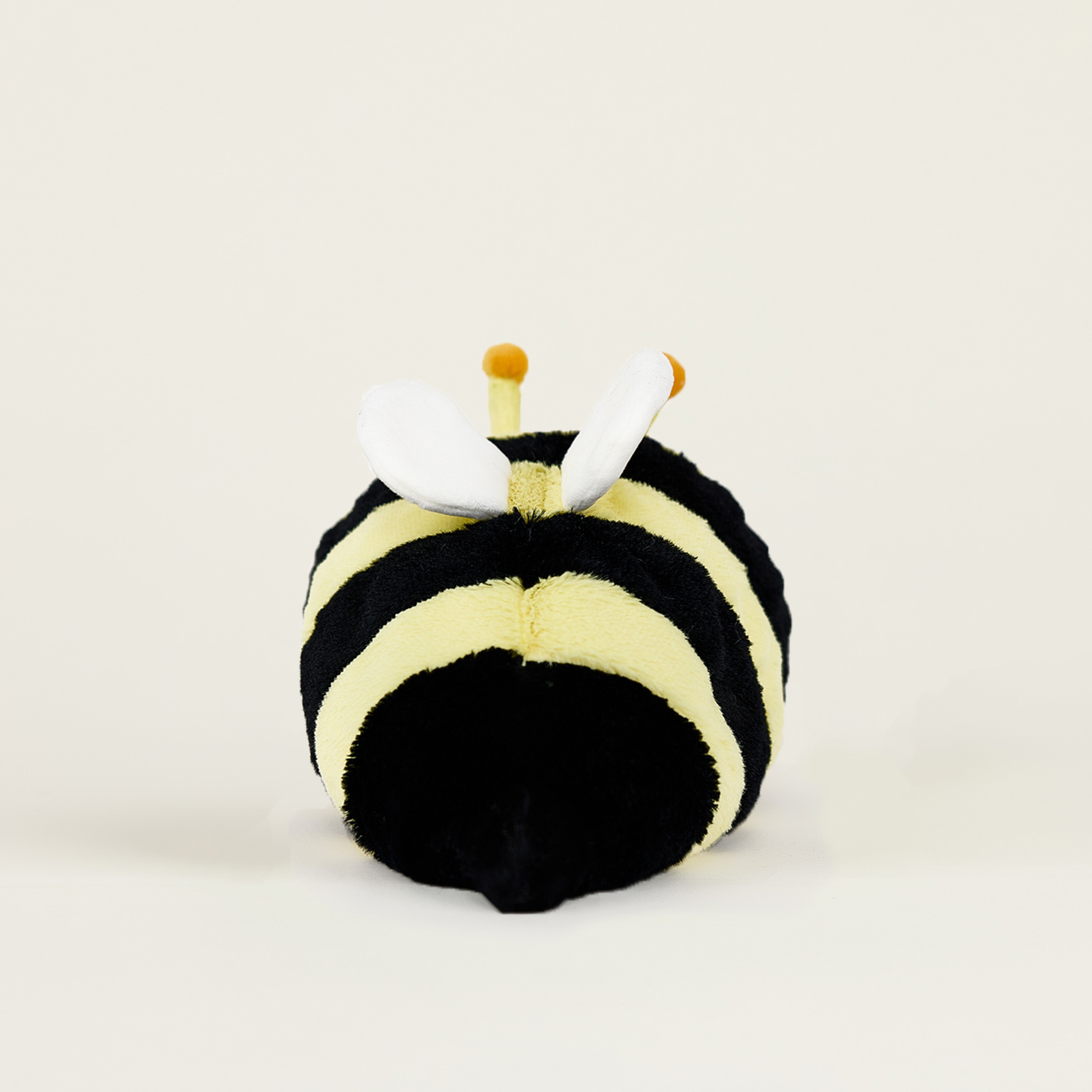 Peluche bouillotte juniors abeille jaune rayée noire, avec ailes blanches et antennes, de dos