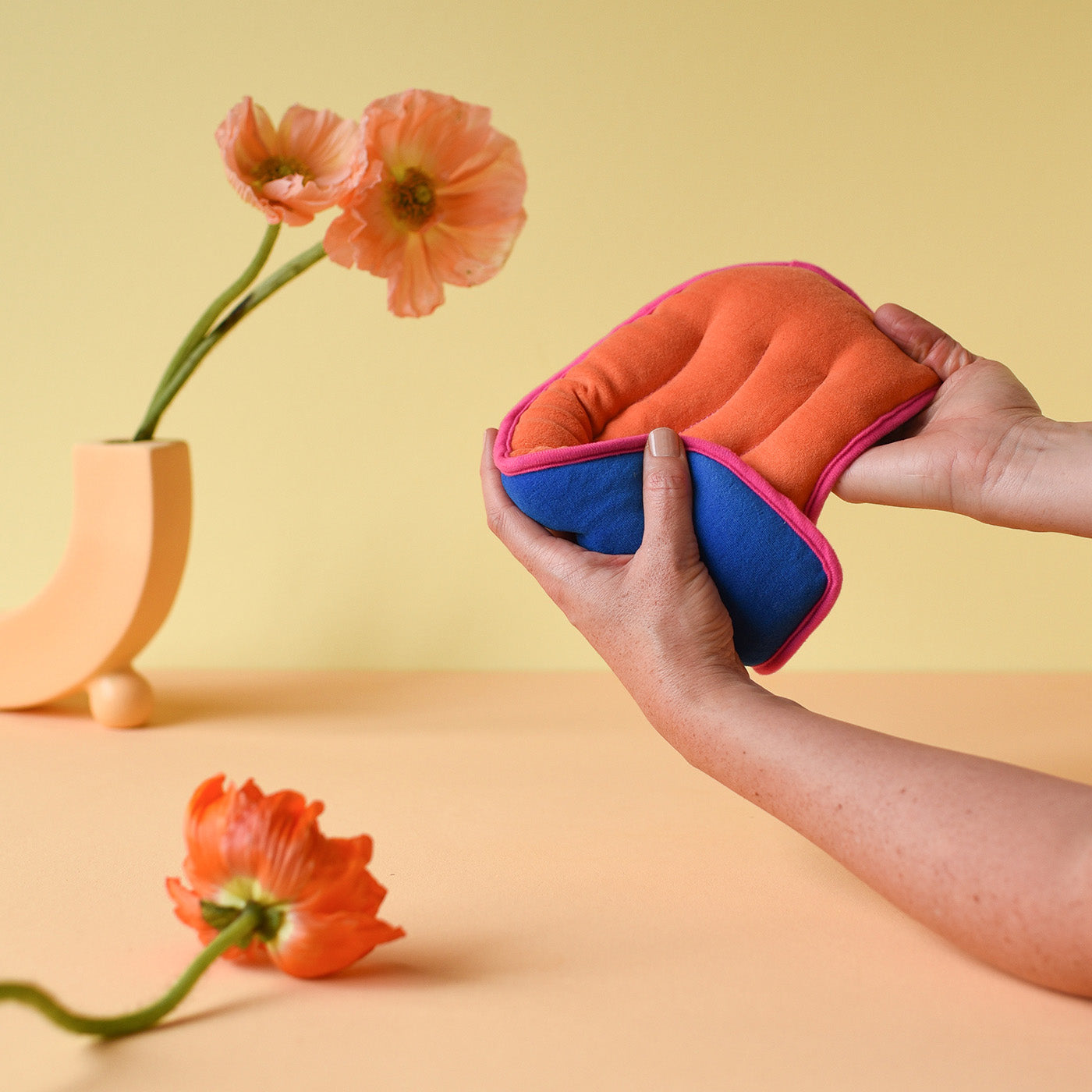 Bouillotte de règles couleurs flashy orange et bleu marine avec bordure rose 