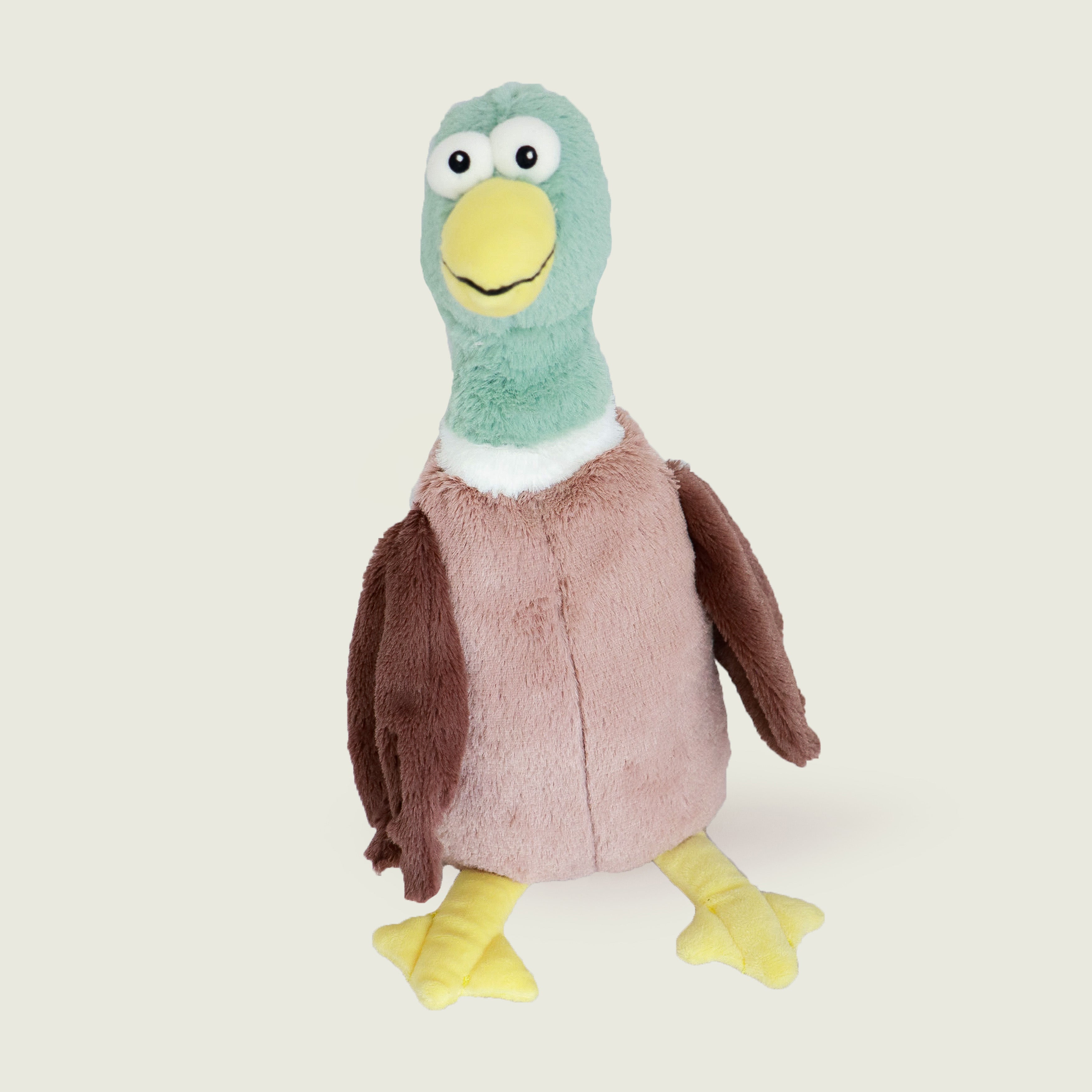 Bouillotte peluche en forme de canard de la marque Warmies, vu de face, avec une tête verte, un bec jaune et un corps marron 