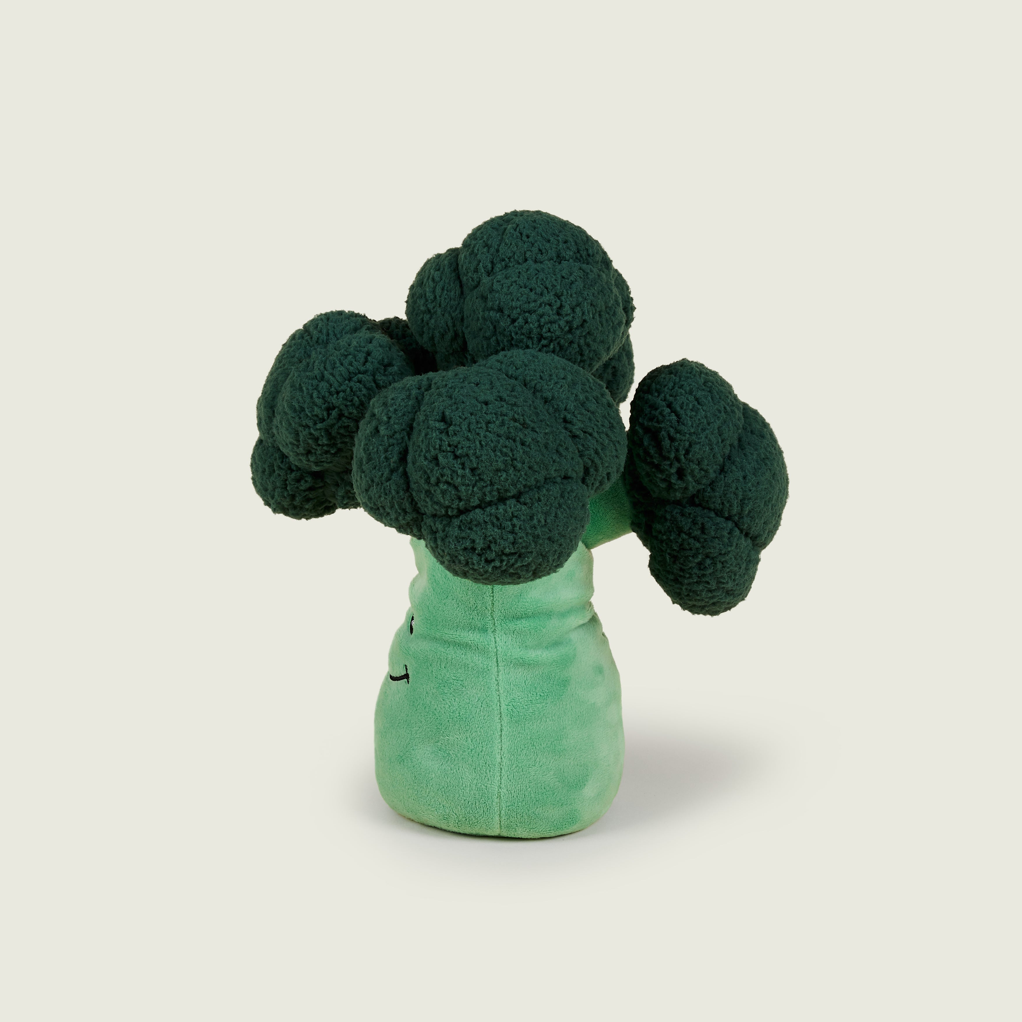 Bouillotte peluche en forme de brocoli positionné sur le profil gauche