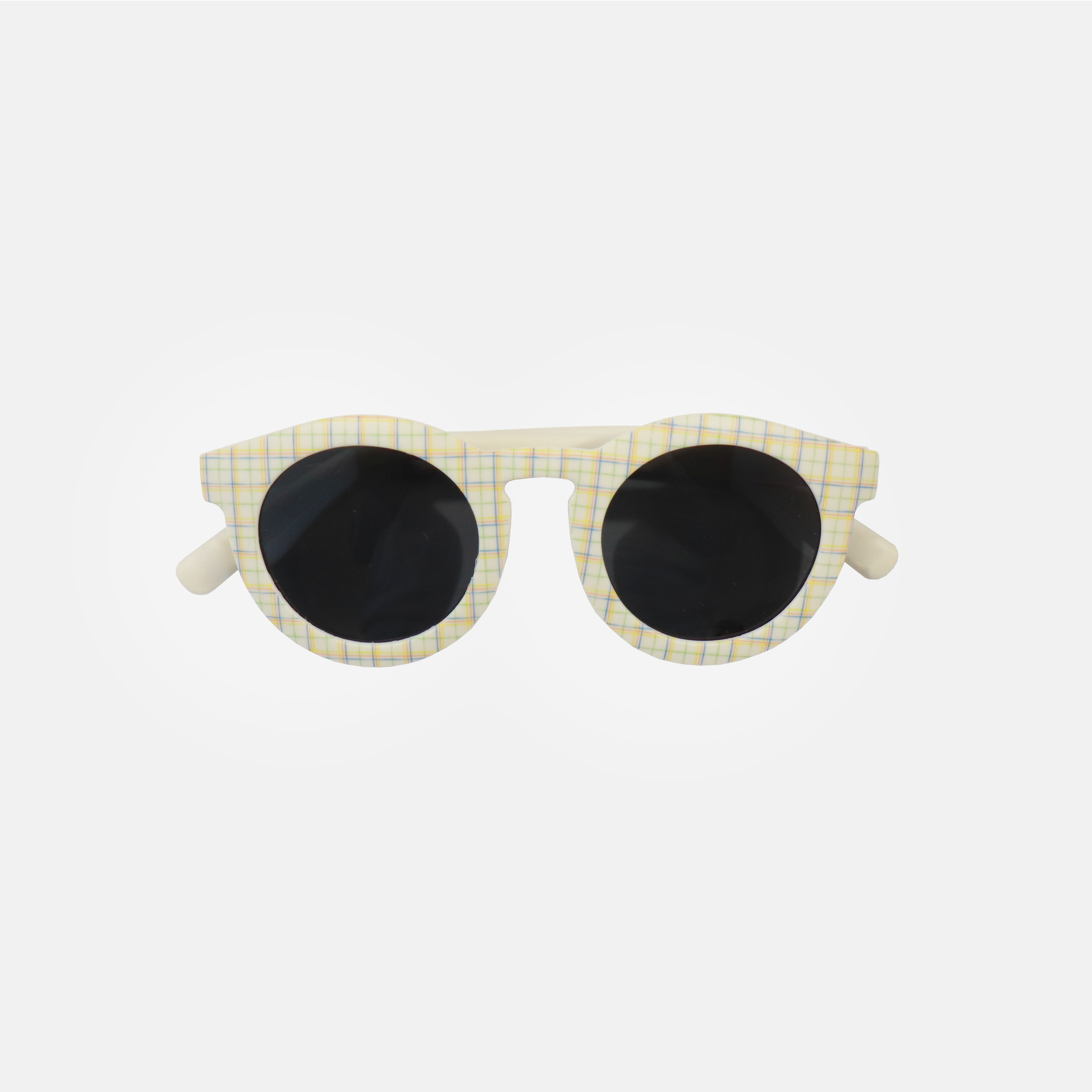 Lunettes de soleil pour adulte avec monture ronde à motif tartan, branches souples créme, et verres noirs polarisés – modèle Hop'Pop CAT3, conçu pour une haute protection anti-UV.