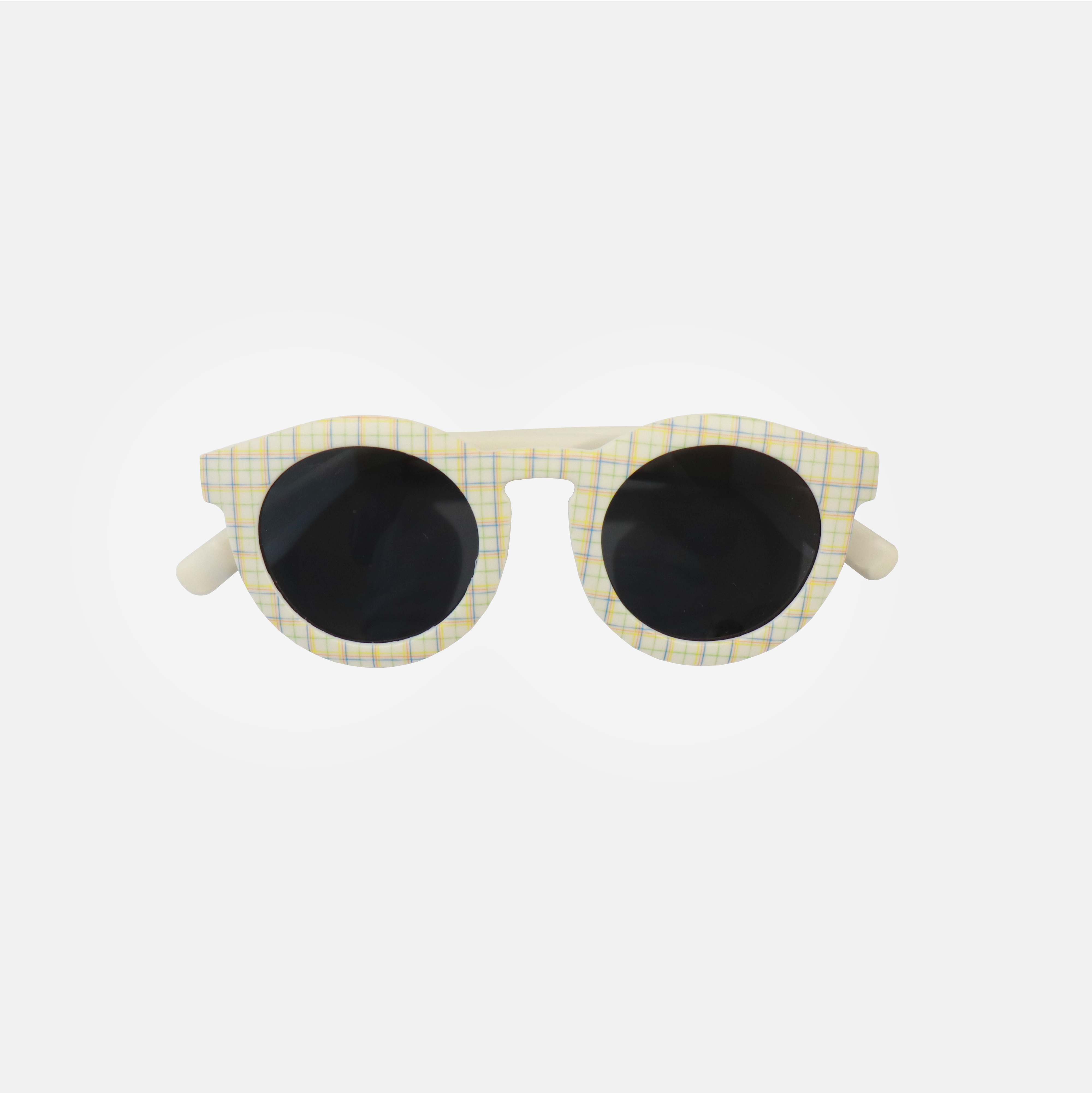 Lunettes de soleil pour adulte avec monture ronde à motif tartan, branches souples créme, et verres noirs polarisés – modèle Hop'Pop CAT3, conçu pour une haute protection anti-UV.
