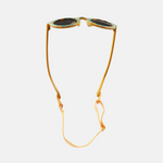 Lunettes de soleil pour enfants avec monture ronde à motif vichy bleu et moutarde, branches souples moutarde, et verres noirs polarisés – modèle Hop'Pop CAT4, conçu pour une haute protection anti-UV.