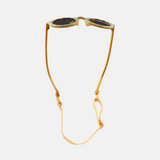 Lunettes de soleil pour enfants avec monture ronde à motif vichy bleu et moutarde, branches souples moutarde, et verres noirs polarisés – modèle Hop'Pop CAT4, conçu pour une haute protection anti-UV.