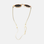 Lunettes de soleil pour enfants avec monture ronde à motif rayée rouge, branches souples crème, et verres noirs polarisés – modèle Hop'Pop CAT4, conçu pour une haute protection anti-UV.