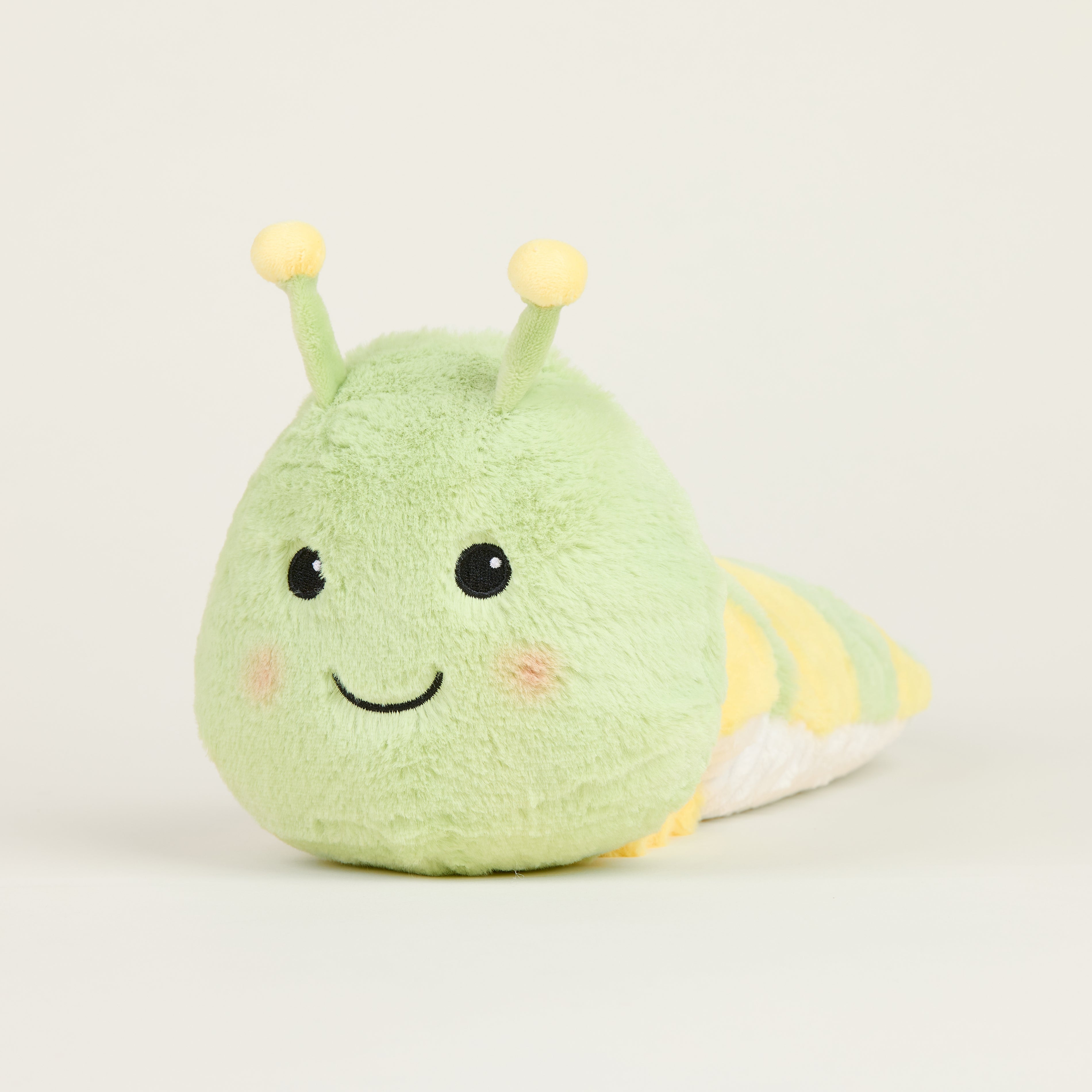 Peluche bouillotte juniors chenille, vert clair et rayée jaune avec antennes et visage souriant 